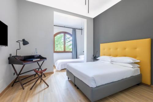 a bedroom with a large bed and a desk at Antico Borgo di Sutri in Sutri