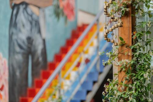 a wall with a fence with a bunch of beads at Baisha Flamingo Hotel in Lijiang