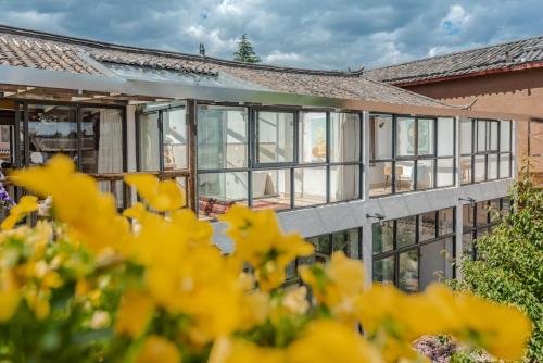 an exterior view of a building with windows at Baisha Flamingo Hotel in Lijiang