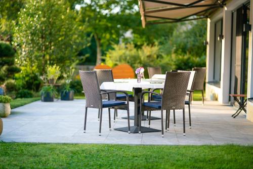a table and chairs sitting on a patio at Garten - Hotel Sallerhof in Salzburg