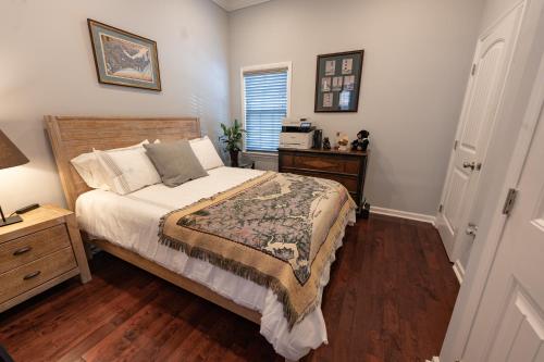 a bedroom with a bed and a table and a window at Remodeled Historic House Walkable to Everything in Raleigh