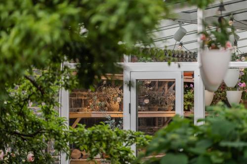 a greenhouse filled with plants and flowers at Baisha Flamingo Hotel in Lijiang