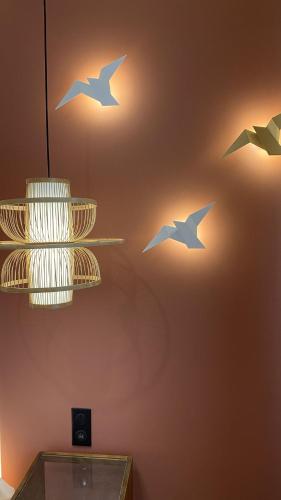 three birds on the wall of a room at Les Granges d'Haillancourt in Ivry-le-Temple