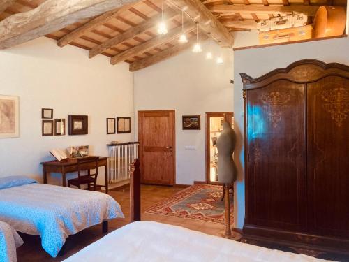 a bedroom with two beds and a table in a room at Mas Teixidor, Masia entre Girona y la Costa Brava in Caldes de Malavella
