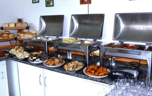 a buffet with many different types of bread and pastries at Hotel Absolar in Alagoinhas
