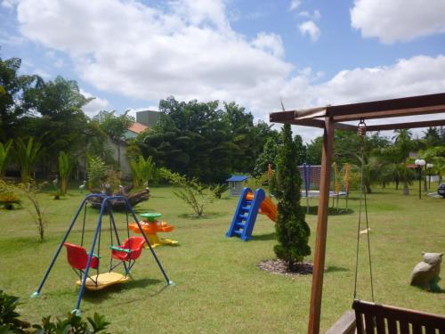 a playground with a swing set in a yard at Hotel Absolar in Alagoinhas