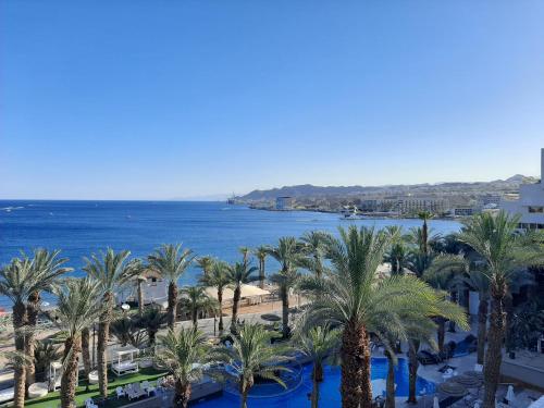 a view of the beach and palm trees and the ocean at Levis house Eilat in Eilat