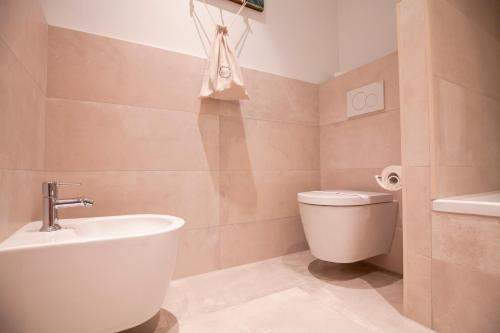 a bathroom with a tub and a toilet and a sink at La Residencia Puerto Hotel & Spa in Tarifa
