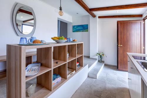 a kitchen with a counter and a mirror at La stanza di Vali in Sperlonga