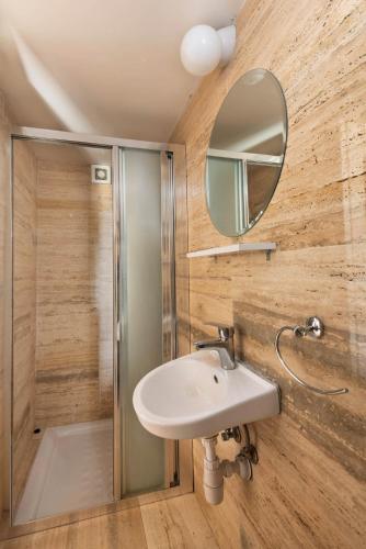 a bathroom with a sink and a mirror at Meleni Cottage Houses in Parekklisha