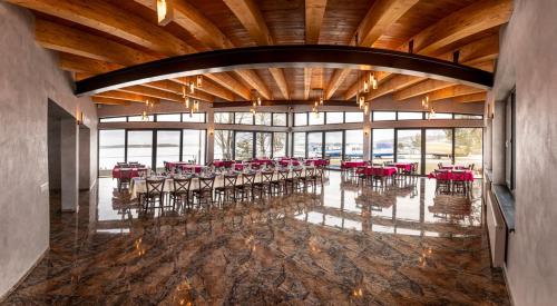 a dining room with tables and chairs in a building at Hotel Prístav in Trstená