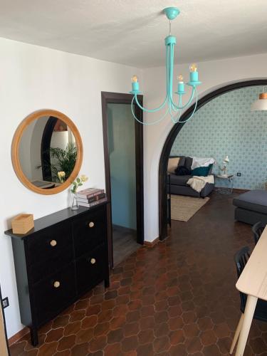 a living room with a mirror and a chandelier at Casa Olalla in Mijas