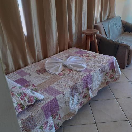 a quilt with a bow on top of a table at PontaNegra Ponta do Sol 5D Luciene Vista deslumbrante para o mar in Natal
