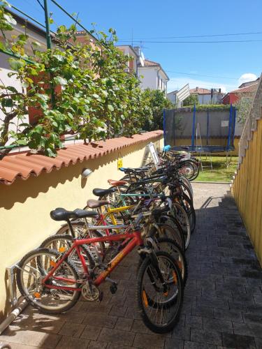 a row of bikes parked next to a wall at Villa Alpa in Umag