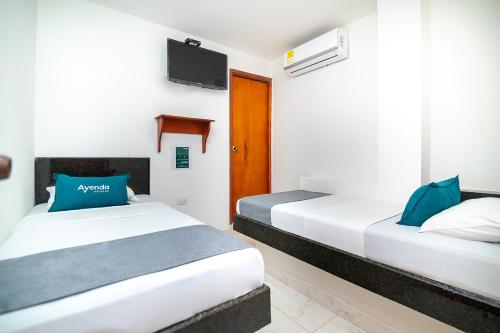 Postel nebo postele na pokoji v ubytování Hotel Esperanza AC