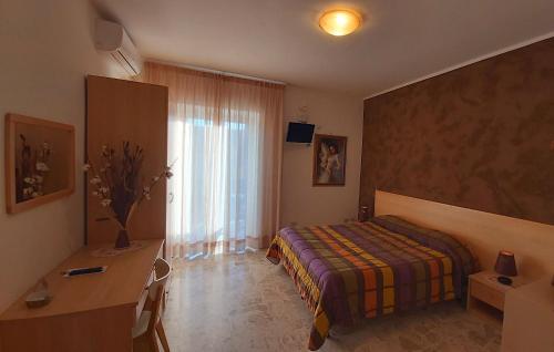 Ένα ή περισσότερα κρεβάτια σε δωμάτιο στο B&B Raggio Di Sole