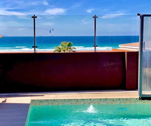 a swimming pool with a view of the ocean at Ed Senses Apartamento Infinity in Tarifa