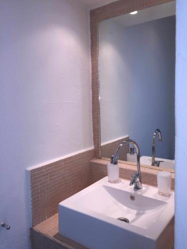 a bathroom with a white sink and a mirror at Ed.Senses. Apto Infinity in Tarifa