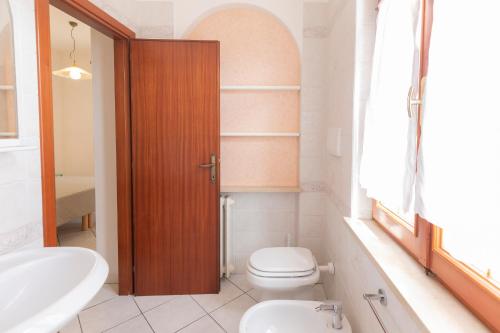 a bathroom with a toilet and a sink at HelloElba Appartamento Azzurro in Marina di Campo