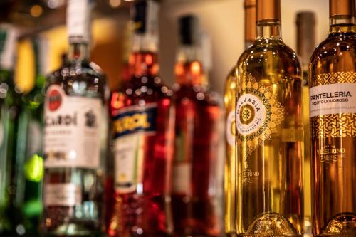 a group of bottles of wine sitting on a bar at Hotel Garibaldi in Milazzo