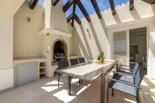 a kitchen and dining room with a table and chairs at Sea View Villa in Sagres