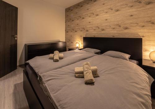a bedroom with a large bed with two towels on it at Gesto Apartments in Prague