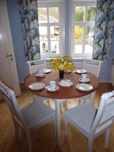 a dining room table and chairs with flowers on it at Forsthaus in Waldhessen in Bauhaus