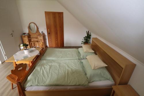 a bedroom with a large bed and a table at Gästehaus Ulbl in Kitzeck im Sausal