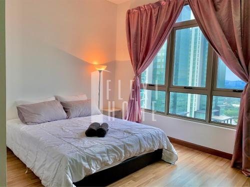 Un dormitorio con una cama con dos zapatos negros. en 9am-5pm, SAME DAY CHECK IN AND CHECK OUT, Work From Home, Shaftsbury-Cyberjaya, Comfy Home by Flexihome-MY, en Cyberjaya