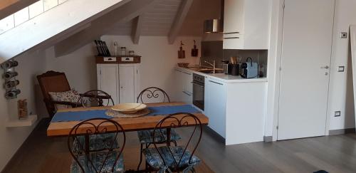 a kitchen with a table and chairs and a kitchen with white cabinets at Bellagio Holiday Home in Bellagio