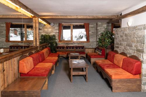 a room with couches and a table and windows at Résidence Le Chamois d'Or in Val Thorens