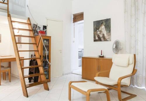 a living room with a ladder and a chair at MELLINI HOUSE in Rome