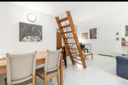 a room with a table and a wooden ladder at MELLINI HOUSE in Rome