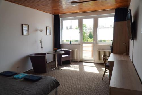 a room with a bed and a table and a window at M-Tourist in Prague