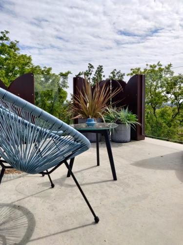 a blue bench and a table on a patio at Hotel Castello S. Antonio in Lazise
