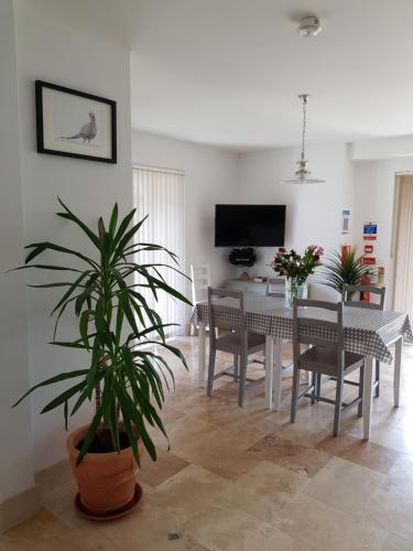 a living room with a table and a dining room at Tirah Guest House in Aldeburgh