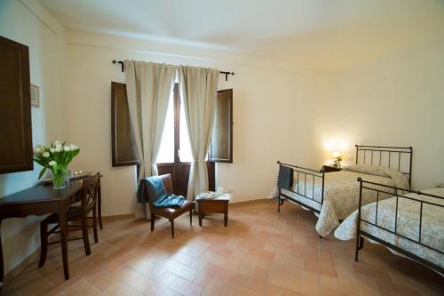 a bedroom with a bed and a desk and a chair at Convento San Bernardino in Montefranco