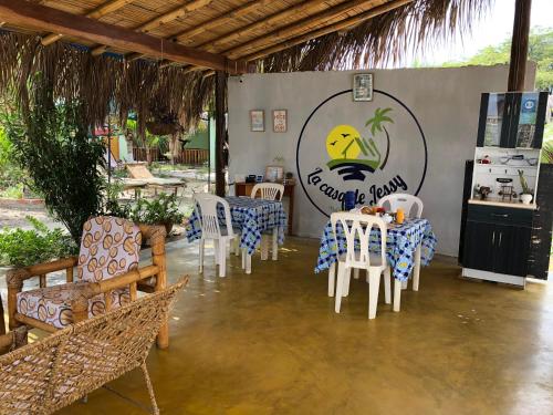 a restaurant with tables and chairs and a sign at La Casa de Jessy in Máncora