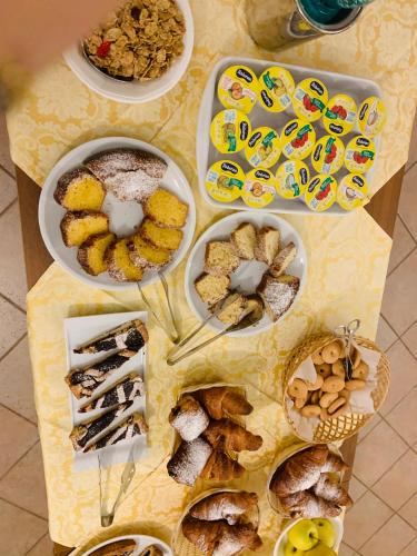 a table with several plates of food on it at Hotel Janas in Tertenìa