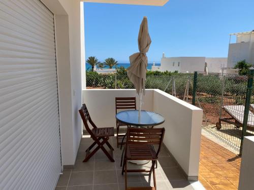 a patio with a table and chairs on a balcony at Mda Playa del Cantal in Mojácar