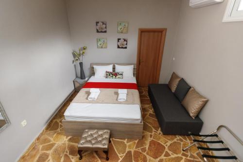 a small bedroom with a bed and a couch at Wooden House in Mesimérion