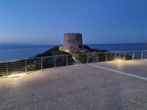 a castle on an island in the ocean at night at Bilocale Conti in Santa Teresa Gallura