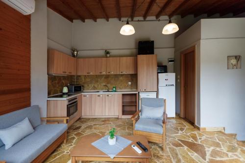 a kitchen with a couch and a table at Wooden House in Mesimérion