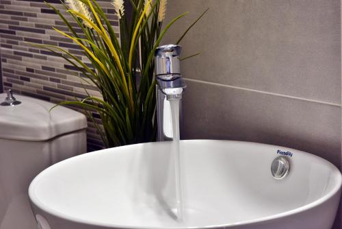 a white sink with a faucet in a bathroom at House in Εndless green - Arethousa, Ikaria in Évdhilos