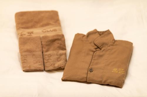 two pieces of brown clothing sitting on a table at Hotel Chapel Sweet (Adult Only) in Kobe
