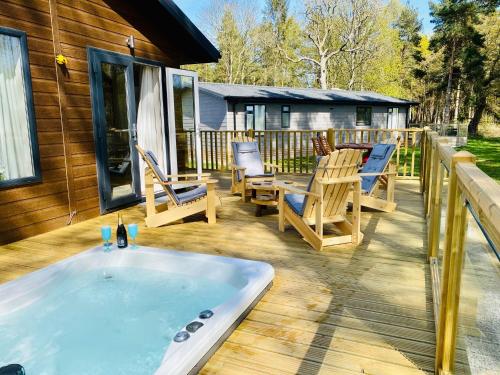 a hot tub on the deck of a house at Hollicarrs - Wildflower Lodge in York