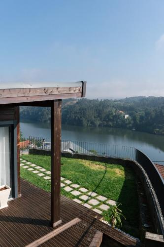 a view of a lake from a house with a deck at Quinta do Pomar Maior Douro - Porto Carvoeiro in Porto Carvoeiro
