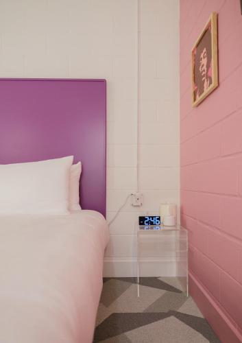 a bedroom with a bed and an alarm clock at The Gallatin in Nashville