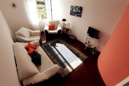 a living room with two chairs and a table at Apartamento Beira-Mar in Ribeira Grande