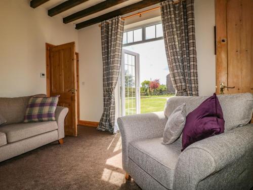 a living room with a couch and a window at Hillcrest in Retford